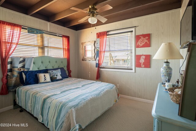 714 Ocean Blvd, Topsail Beach, NC 28445 - carpeted bedroom with multiple windows, baseboards, and wood walls