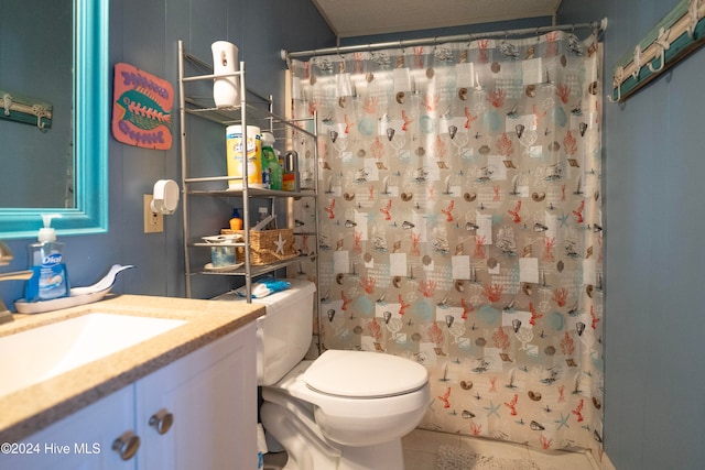 bathroom featuring tile patterned floors, vanity, toilet, and curtained shower