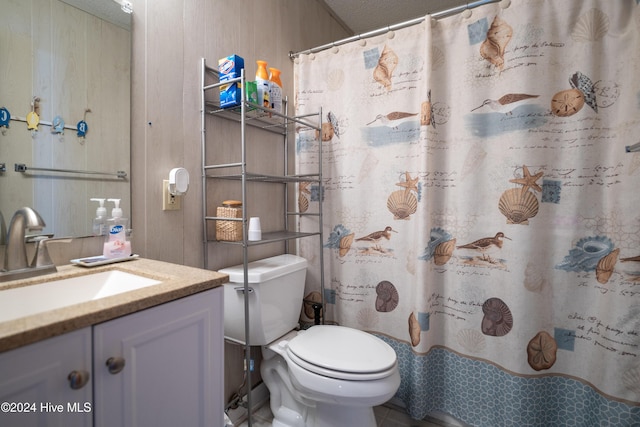 714 Ocean Blvd, Topsail Beach, NC 28445 - full bath featuring vanity, toilet, a shower with shower curtain, and wooden walls