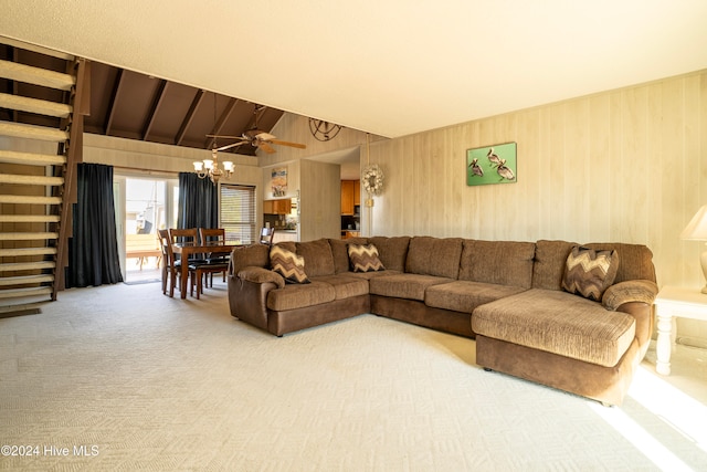 living room with ceiling fan, wood walls, lofted ceiling, and carpet floors