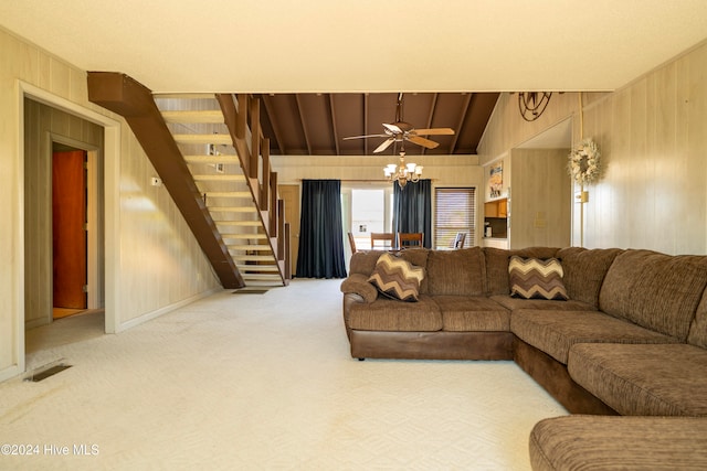 carpeted living room featuring ceiling fan, lofted ceiling, and wooden walls