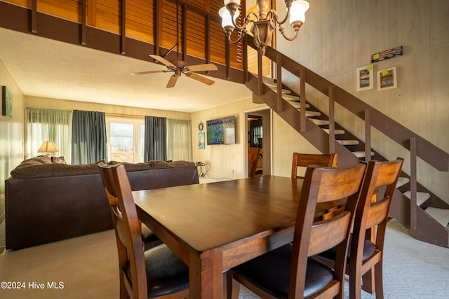 dining space with light carpet and ceiling fan