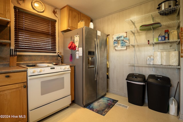 714 Ocean Blvd, Topsail Beach, NC 28445 - kitchen with white electric stove, stainless steel refrigerator with ice dispenser, and brown cabinets