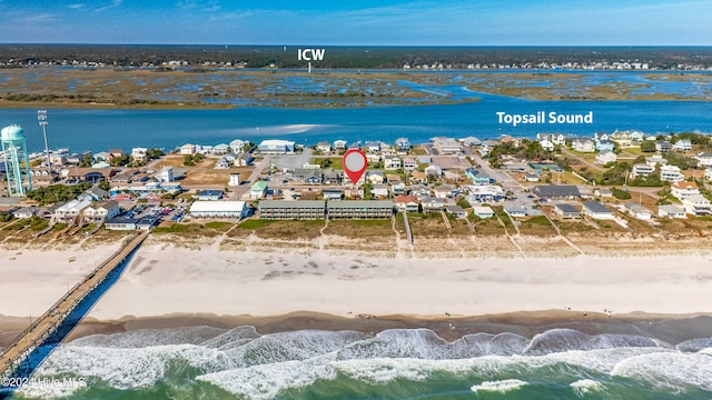 drone / aerial view featuring a beach view and a water view