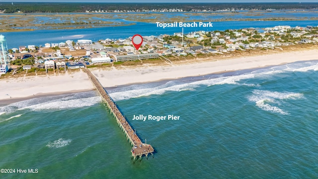 birds eye view of property with a water view and a view of the beach