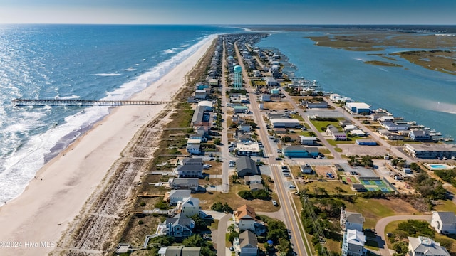 bird's eye view featuring a water view and a beach view