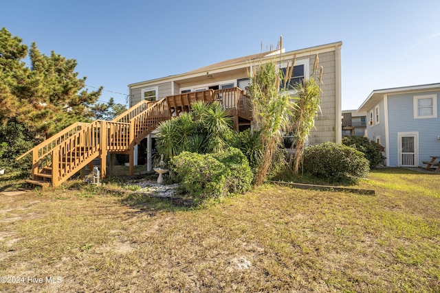 714 Ocean Blvd, Topsail Beach, NC 28445 - back of property with stairway, a wooden deck, and a yard