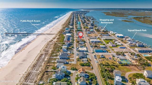 birds eye view of property with a water view and a view of the beach