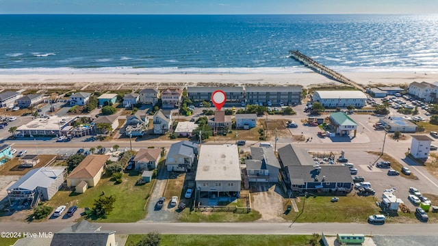 drone / aerial view featuring a water view and a beach view