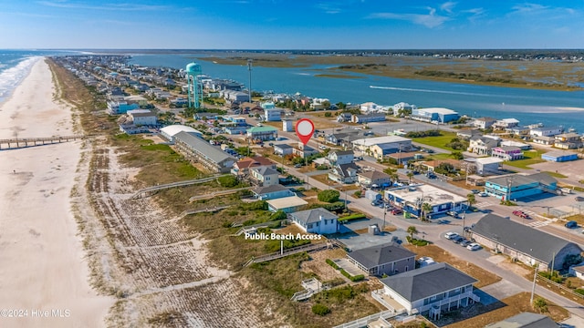 birds eye view of property with a water view and a view of the beach