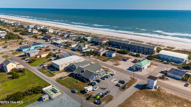 birds eye view of property with a water view and a view of the beach