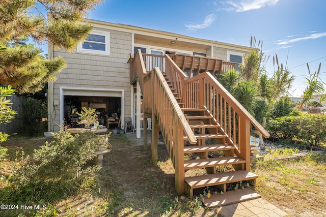 714 Ocean Blvd, Topsail Beach, NC 28445 - back of property featuring stairs, an attached garage, and a wooden deck