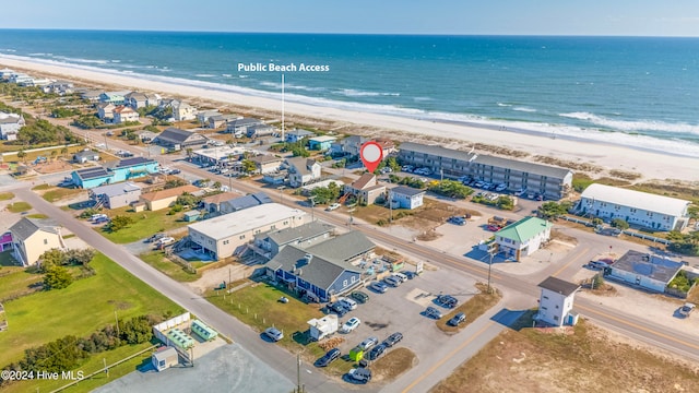 birds eye view of property featuring a view of the beach and a water view