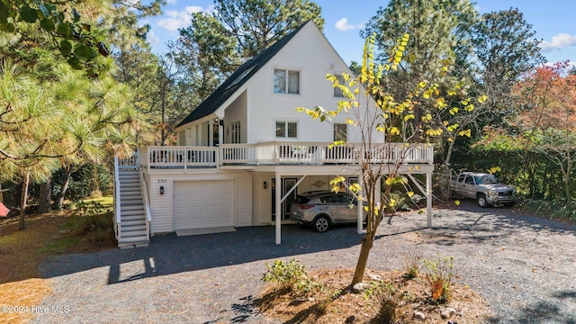 view of front of home featuring a wooden deck, a garage, and a carport