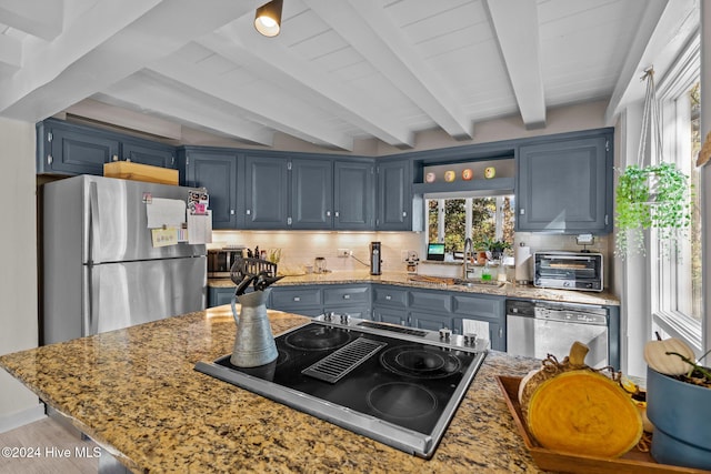 kitchen with blue cabinetry, light stone countertops, sink, stainless steel appliances, and beamed ceiling