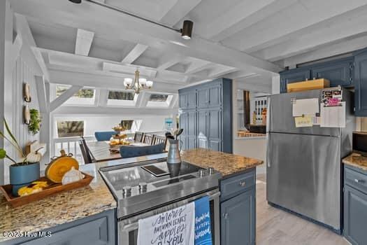 kitchen with blue cabinetry, beam ceiling, light stone countertops, a chandelier, and appliances with stainless steel finishes