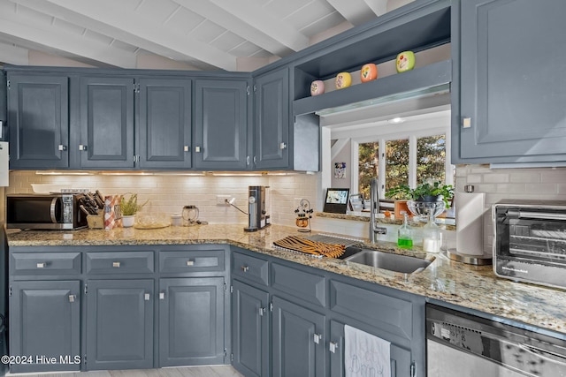 kitchen featuring beam ceiling, sink, stainless steel appliances, tasteful backsplash, and blue cabinets