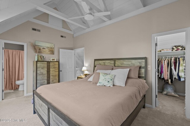 bedroom featuring high vaulted ceiling, ceiling fan, connected bathroom, light colored carpet, and a closet