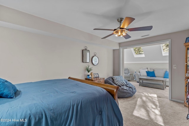 bedroom with carpet, a skylight, and ceiling fan