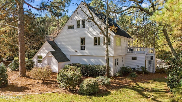 back of property featuring a lawn and a wooden deck