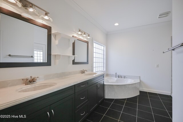 bathroom featuring tile patterned flooring, vanity, crown molding, and a washtub