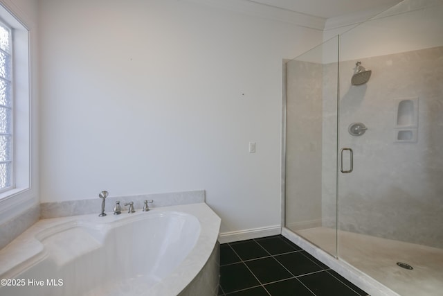 bathroom with tile patterned flooring, vanity, a tub to relax in, and crown molding