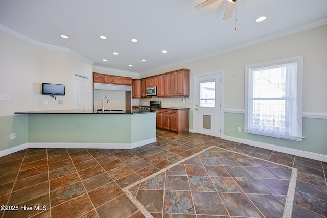 kitchen featuring ceiling fan and crown molding