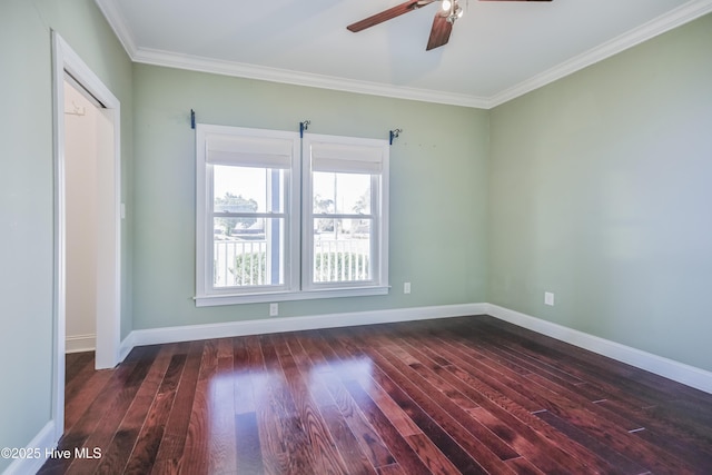 unfurnished bedroom featuring a walk in closet, crown molding, ceiling fan, dark hardwood / wood-style floors, and a closet