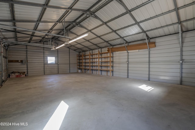 garage with a garage door opener and a carport