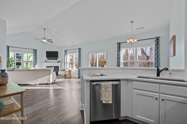 kitchen featuring sink, stainless steel dishwasher, dark hardwood / wood-style floors, a healthy amount of sunlight, and white cabinets