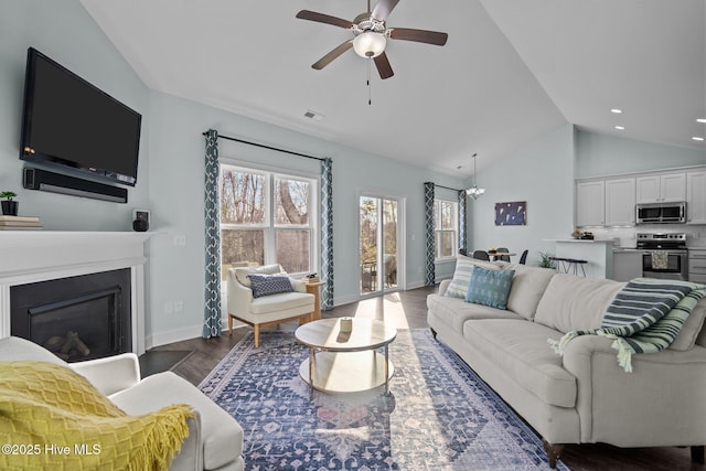 living room with ceiling fan, high vaulted ceiling, and dark hardwood / wood-style flooring