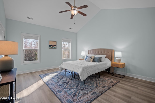 bedroom featuring multiple windows, high vaulted ceiling, hardwood / wood-style floors, and ceiling fan