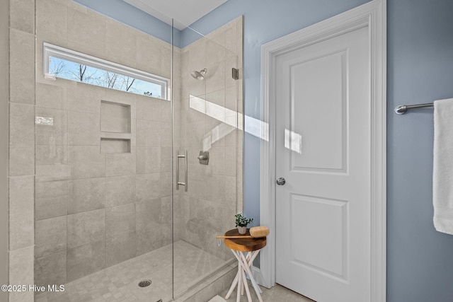 bathroom with a shower with door