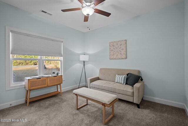 living room featuring carpet and ceiling fan