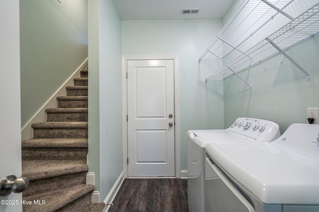 washroom with washer and dryer and dark hardwood / wood-style flooring