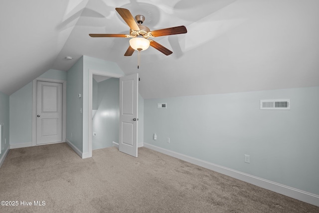 additional living space featuring lofted ceiling, light carpet, and ceiling fan