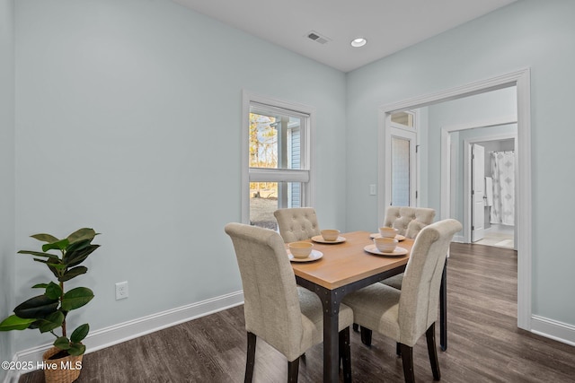 dining area with dark hardwood / wood-style flooring