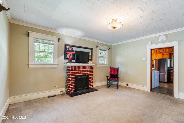 sitting room featuring a fireplace, carpet floors, and crown molding