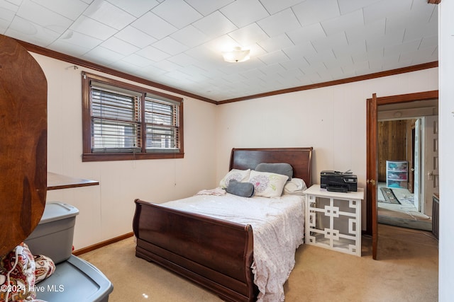 carpeted bedroom with ornamental molding