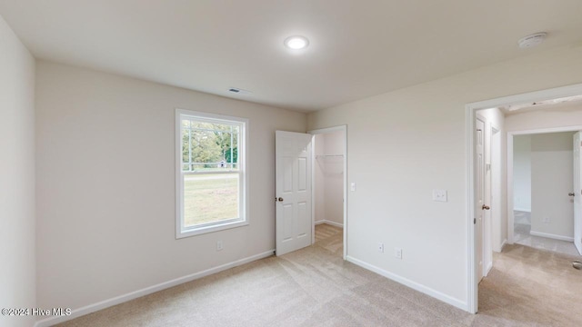 unfurnished bedroom featuring light colored carpet