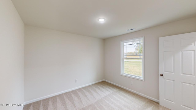 unfurnished room featuring light colored carpet