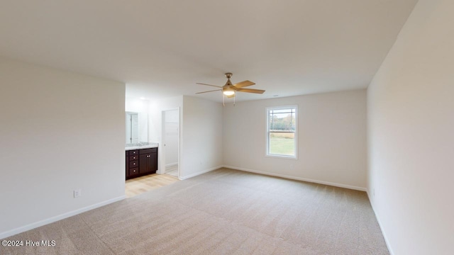 unfurnished room featuring light carpet and ceiling fan