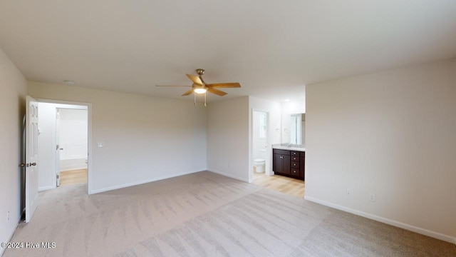 unfurnished room featuring ceiling fan and light colored carpet