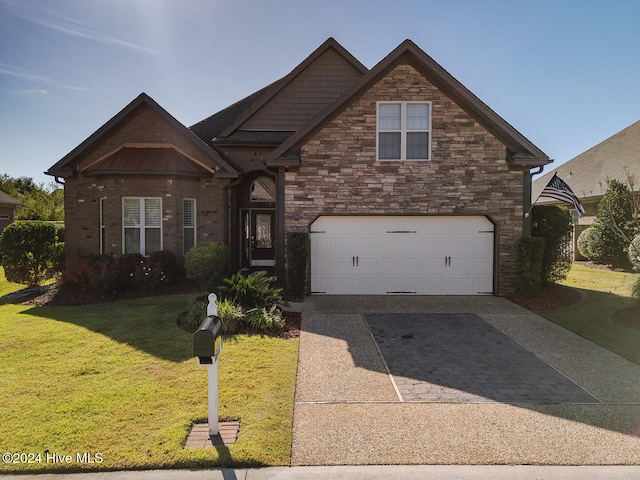 view of property featuring a garage and a front lawn