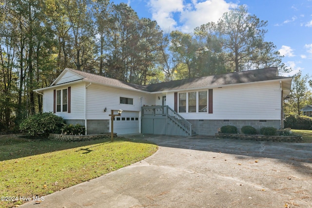 ranch-style house featuring a garage and a front lawn