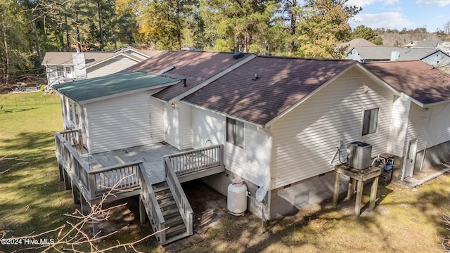 exterior space featuring a yard, central air condition unit, and a wooden deck