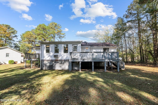 rear view of house featuring a deck and a lawn