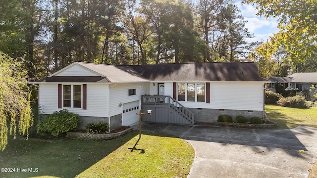 single story home featuring a garage and a front yard