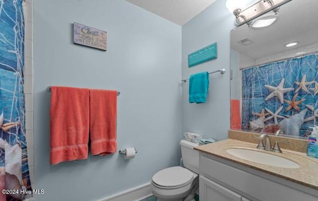 bathroom with vanity, toilet, and walk in shower