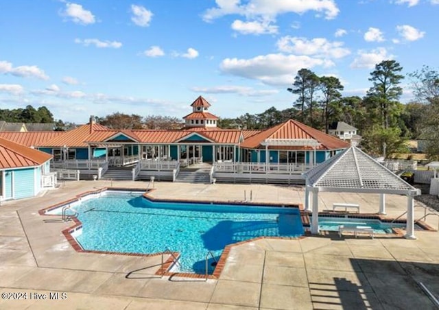 view of swimming pool with a gazebo, a patio area, and a wooden deck